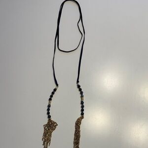 Necklace.  Navy ribbon with navy blue stones at the end and gold tone tassels.